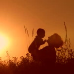 stock-footage-silhouettes-mother-and-baby-sunset
